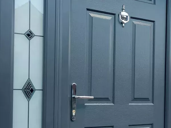 A Front Door With A Decorative Side Panel